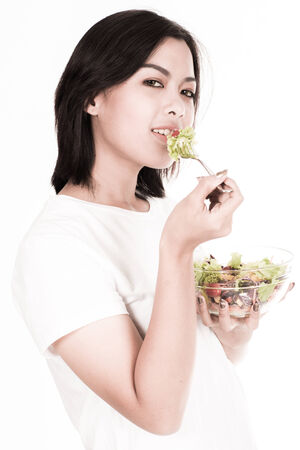 portrait of a lovely young woman eating healthyの写真素材