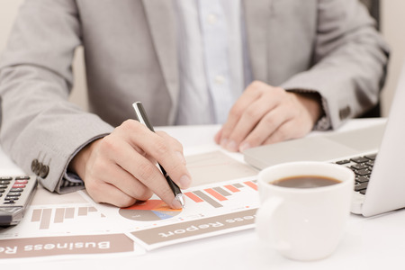 Businessman analyzing investment charts with laptop. Accountingの写真素材