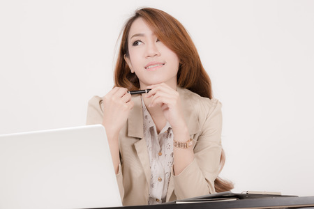 Portrait of a young business woman using laptop at officeの写真素材