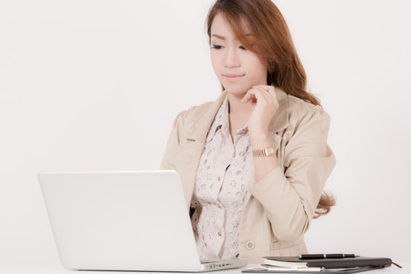 Portrait of a young business woman using laptop at officeの写真素材