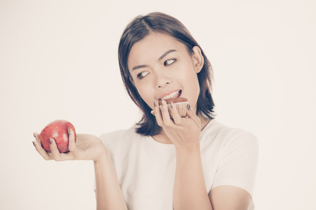 Smiling woman with apple isolated on whiteの写真素材