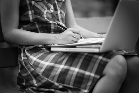 Beautiful young woman using laptop in parkの写真素材