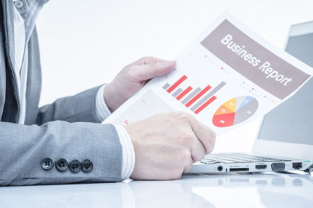 Businessman analyzing investment charts with laptop. Accountingの写真素材