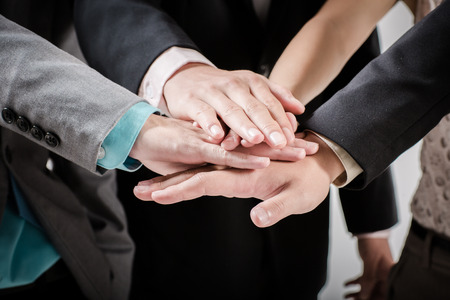 Business group with hands together - teamwork concepts