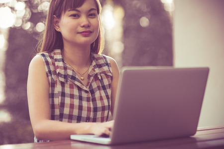 a young asian woman using laptopの写真素材