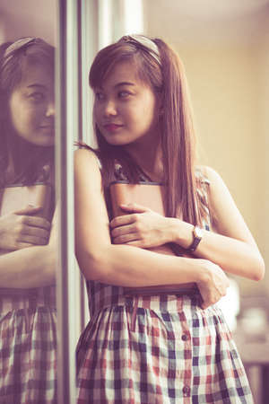 Portrait of smiling woman hold bookの写真素材