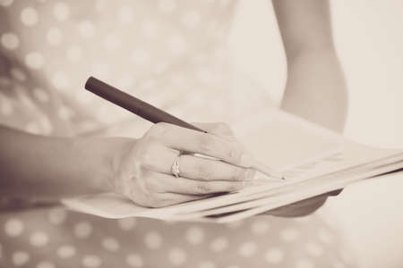 woman hand with pen and business report