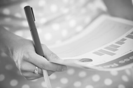 woman hand with pen and business reportの写真素材