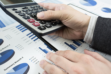 man hand with pen and business report. Accounting