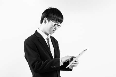 Asian business man using tablet computer isolated on white backgroundの写真素材