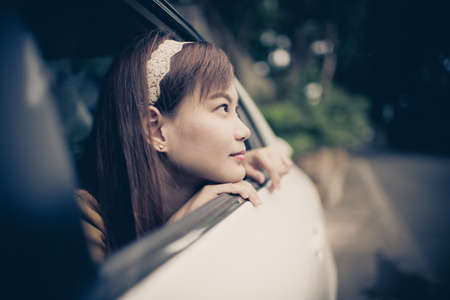 oung woman in her new car smiling.の写真素材