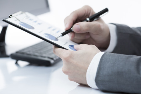 Businessman analyzing investment charts with computer. Accountingの写真素材