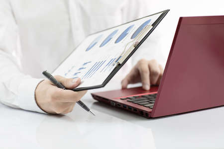 Businessman analyzing investment charts with laptop. Accountingの写真素材