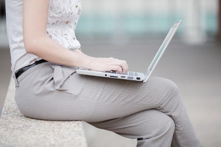 Beautiful young woman using laptopの写真素材