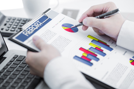 Businessman analyzing investment charts with laptop. Accountingの写真素材