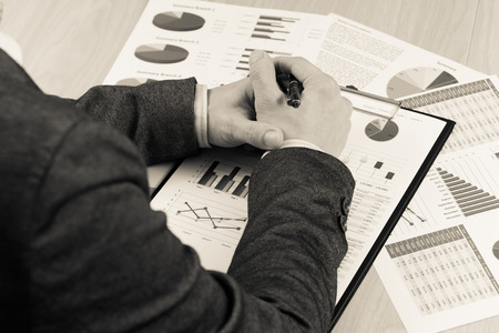 man hand with pen and business report. Accountingの写真素材