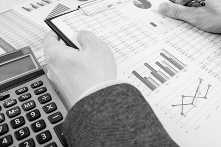 man hand with pen and business report. Accountingの写真素材