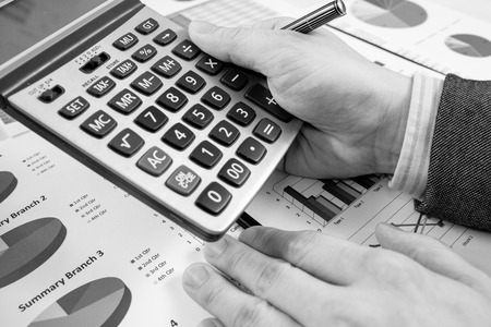 man hand with pen and business report. Accountingの写真素材