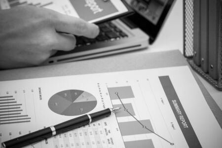 Businessman analyzing investment charts with laptop. Accountingの写真素材