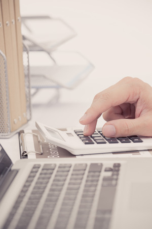 Businessman analyzing investment charts with laptop. Accountingの写真素材