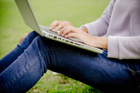 Young Caucasian woman using Laptop on natureの写真素材