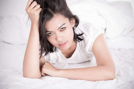 Portrait of a beautiful young woman in bedの写真素材