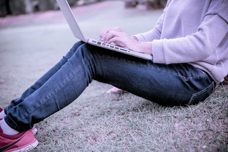 Young Caucasian woman using Laptop on natureの写真素材