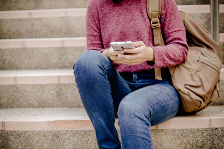 attractive female college student sitting on stairs