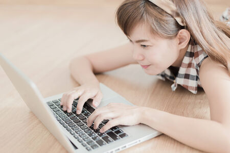 Asian woman using laptop at homeの写真素材
