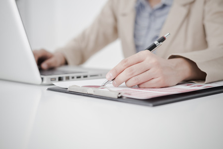 woman hand with business reportの写真素材