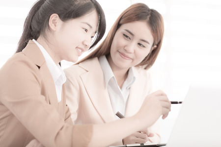 Business people discussing the charts and graphs showing the results of their successful teamworkの写真素材