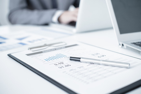 Business people discussing the charts and graphs showing the results of their successful teamworkの写真素材