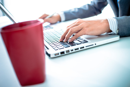 Closeup of businessman hands typing on laptop computerの写真素材