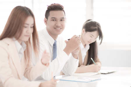 Business people discussing the charts and graphs showing the results of their successful teamworkの写真素材