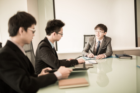 Young business people sitting in board room during meeting and discussing with paperwork.Asianの写真素材