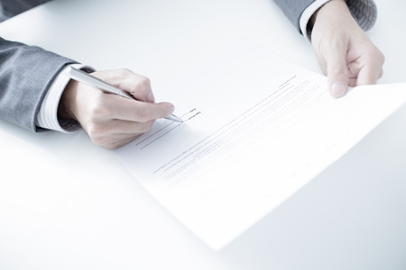 Business man signing a contractの写真素材