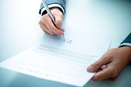 Business man signing a contractの写真素材