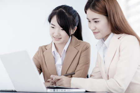 Business people discussing the charts and graphs showing the results of their successful teamworkの写真素材