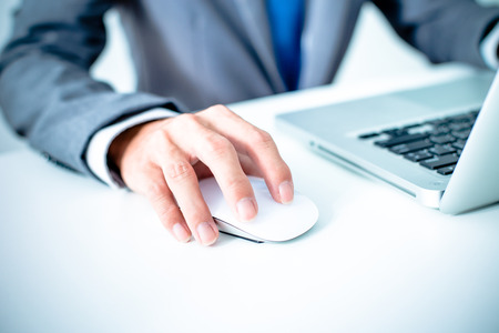 Closeup of businessman hands typing on laptop computerの写真素材