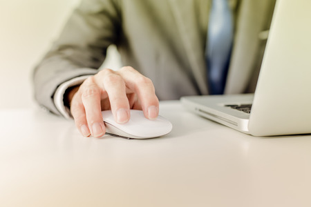 Closeup of businessman hands typing on laptop computerの写真素材