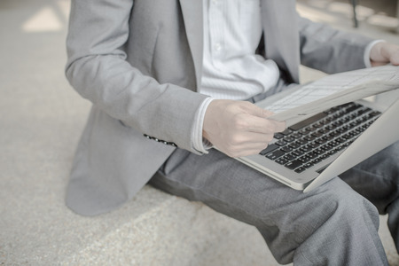 Young successful young man holding a newspaperの写真素材