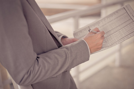 Young business man with newspaper sitting on the stairs.の写真素材