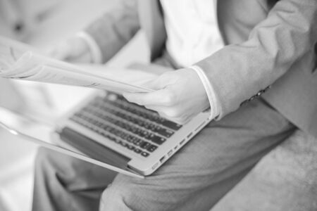 Young successful young man holding a newspaperの写真素材