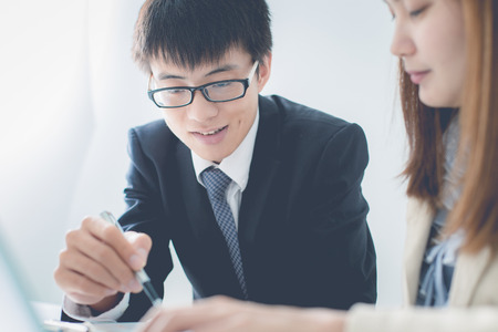 Business people discussing the charts and graphs showing the results of their successful teamworkの写真素材