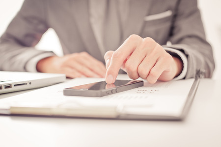business, technology and internet concept - close up of man hands with coffee and laptop computer