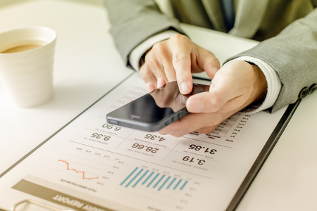 business, technology and internet concept - close up of man hands with coffee and laptop computerの写真素材