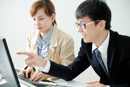 Business people discussing the charts and graphs showing the results of their successful teamworkの写真素材