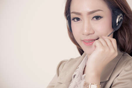 Portrait of happy smiling cheerful support phone operator in headset, isolated on white backgroundの写真素材