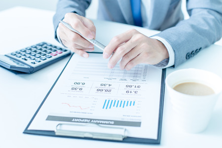 business, technology and internet concept - close up of man hands with coffee and laptop computerの写真素材
