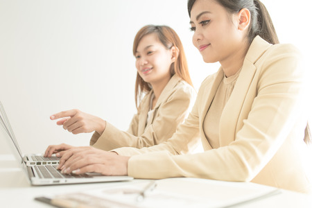 Business people discussing the charts and graphs showing the results of their successful teamworkの写真素材